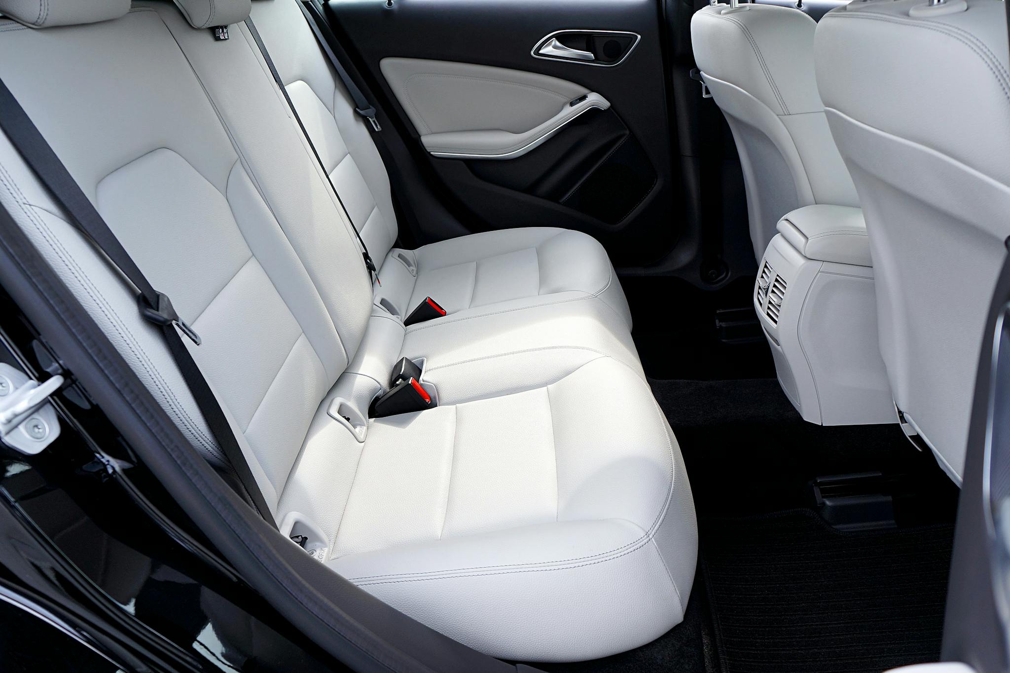 Explore the modern and luxurious feel of a car's interior with pristine white leather seats.